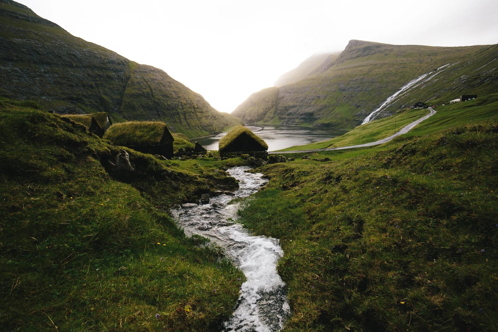 A stream running between green hills in Saksun, Faroe Islands