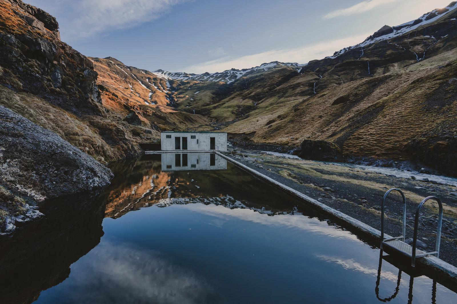 Open-air pool between the walls of a valley at Seljavallalaug in southern Iceland